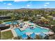 Stunning aerial view of a community pool area with lush greenery, seating, and crystal-clear waters at 30374 N 124Th Dr, Peoria, AZ 85383