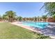 Beautiful community pool with lush landscaping and palm trees, providing a serene oasis for relaxation and recreation at 30374 N 124Th Dr, Peoria, AZ 85383