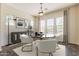 Dining room with modern chandelier, neutral paint, and large windows for lots of light at 30374 N 124Th Dr, Peoria, AZ 85383