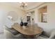 Dining room with a modern chandelier, neutral walls, and ample natural light at 30374 N 124Th Dr, Peoria, AZ 85383