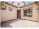 Inviting front entrance with a striking wood door, decorative lighting, and a paver patio at 30374 N 124Th Dr, Peoria, AZ 85383