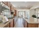 Spacious kitchen with granite countertops, tile backsplash, stainless appliances, and center island overlooking breakfast nook at 30374 N 124Th Dr, Peoria, AZ 85383