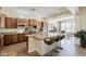 Well-appointed kitchen with large granite island, stainless appliances, and adjacent breakfast nook at 30374 N 124Th Dr, Peoria, AZ 85383