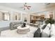Bright living room that seamlessly connects to a gourmet kitchen, perfect for entertaining and everyday living at 30374 N 124Th Dr, Peoria, AZ 85383