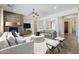 Open-concept living room with a striking stone fireplace, neutral color palette, and plenty of natural light at 30374 N 124Th Dr, Peoria, AZ 85383