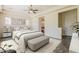 Bright main bedroom with neutral walls, a ceiling fan, and an ensuite bathroom at 30374 N 124Th Dr, Peoria, AZ 85383