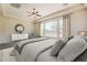 Spacious main bedroom with neutral walls, a ceiling fan, and a large window for natural light at 30374 N 124Th Dr, Peoria, AZ 85383