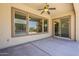 Covered patio with views of the pool and backyard through expansive windows and sliding doors at 30374 N 124Th Dr, Peoria, AZ 85383