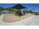 Charming playground with slides and shaded seating, creating a fun and safe environment for children to play at 30374 N 124Th Dr, Peoria, AZ 85383
