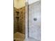 Walk-in shower featuring tile walls, a rainfall shower head, and a built-in shelf at 30374 N 124Th Dr, Peoria, AZ 85383