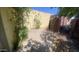 Backyard area with simple landscaping, partial fence, and shade at 3404 W Tangerine Ln, Phoenix, AZ 85051