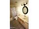 This bathroom features a single sink and vanity, tiled floors, and a shower/tub at 3404 W Tangerine Ln, Phoenix, AZ 85051