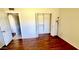 Bedroom with hardwood floors, closet, and neutral color palette at 3404 W Tangerine Ln, Phoenix, AZ 85051