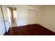 Bright bedroom with hardwood floors, large closet, and an open doorway to the hall at 3404 W Tangerine Ln, Phoenix, AZ 85051