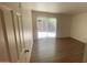 Bedroom featuring a sliding door that lets in natural light and wood look flooring at 3404 W Tangerine Ln, Phoenix, AZ 85051
