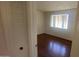 Cozy bedroom featuring hardwood floors and a bright window at 3404 W Tangerine Ln, Phoenix, AZ 85051