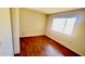 This bedroom features wood floors, neutral walls, and a bright window at 3404 W Tangerine Ln, Phoenix, AZ 85051