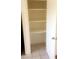 Open closet reveals ample shelving and tile flooring, offering plenty of storage space at 3404 W Tangerine Ln, Phoenix, AZ 85051