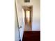 Hallway view with tile floor and open doorway to a bedroom at 3404 W Tangerine Ln, Phoenix, AZ 85051