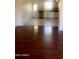 Open living space with view to the kitchen and beautiful dark hardwood flooring at 3404 W Tangerine Ln, Phoenix, AZ 85051