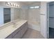 Bathroom featuring a vanity, large mirror, and a shower-tub combo at 3407 N 67Th Ln, Phoenix, AZ 85033