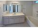 Well-lit bathroom featuring a vanity with ample storage and a shower-tub combo at 3407 N 67Th Ln, Phoenix, AZ 85033
