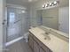 Well-lit bathroom with a glass shower and vanity sink at 3407 N 67Th Ln, Phoenix, AZ 85033