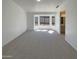 Bright and airy bedroom with a bay window, soft carpet, and access to an ensuite bathroom at 3407 N 67Th Ln, Phoenix, AZ 85033
