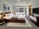 Cozy bedroom featuring a bay window, ensuite bathroom, and a modern bed frame at 3407 N 67Th Ln, Phoenix, AZ 85033
