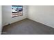 Bedroom with carpet and a window to the street at 3407 N 67Th Ln, Phoenix, AZ 85033