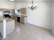 Bright kitchen area featuring a chandelier, tiled floors, and ample counter space at 3407 N 67Th Ln, Phoenix, AZ 85033
