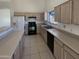 Functional kitchen with neutral countertops and ample cabinet space and black appliances at 3407 N 67Th Ln, Phoenix, AZ 85033