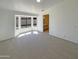 Bright and airy living room featuring a large bay window and neutral carpet at 3407 N 67Th Ln, Phoenix, AZ 85033