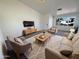 Bright living room with a large front window, cozy seating, and a stylish rug at 3407 N 67Th Ln, Phoenix, AZ 85033