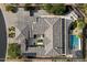 Aerial view of luxury home with solar panels, pool, patio, desert landscape, and circular driveway at 36133 N 24Th Ave, Phoenix, AZ 85086