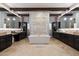 Luxurious main bathroom features a soaking tub, dual vanities, and stylish stone accents at 36133 N 24Th Ave, Phoenix, AZ 85086