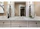 Bathroom with a decorative mirror, stylish sconces, and a marble countertop, offering a blend of elegance at 36133 N 24Th Ave, Phoenix, AZ 85086