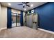 Stylish bedroom featuring murphy bed, blue accent wall, and sliding glass doors to the courtyard at 36133 N 24Th Ave, Phoenix, AZ 85086