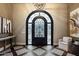 Elegant foyer with decorative tile flooring and an arched wrought iron door at 36133 N 24Th Ave, Phoenix, AZ 85086