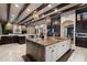 Open-concept kitchen with a large island, custom cabinetry, and easy access to living and dining areas at 36133 N 24Th Ave, Phoenix, AZ 85086