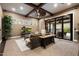 Comfortable living room featuring beamed ceilings, a fireplace, and sliding doors to the patio at 36133 N 24Th Ave, Phoenix, AZ 85086