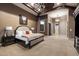 Spacious primary bedroom featuring beamed ceilings, a ceiling fan, and a cozy sitting area at 36133 N 24Th Ave, Phoenix, AZ 85086