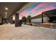 Expansive patio with stone pillars, covered seating area, and seamless access to the pool at 36133 N 24Th Ave, Phoenix, AZ 85086