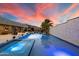 Inviting pool and spa surrounded by desert landscaping, complemented by a captivating sunset backdrop at 36133 N 24Th Ave, Phoenix, AZ 85086