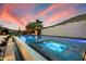 Captivating pool and spa showcasing desert landscaping, set against a mesmerizing sunset backdrop at 36133 N 24Th Ave, Phoenix, AZ 85086