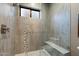 Modern shower features a glass enclosure, built-in bench, and stylish tile accents for a luxurious feel at 36133 N 24Th Ave, Phoenix, AZ 85086