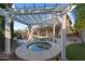 Backyard featuring outdoor living area with a pool and hot tub and rock features at 3822 E Amber Ln, Gilbert, AZ 85296