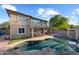Home backyard featuring pool with rock features, an outdoor living area, and green grass at 3822 E Amber Ln, Gilbert, AZ 85296