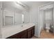 Bathroom featuring a large mirror, a vanity with dark wood cabinets, and a toilet at 3822 E Amber Ln, Gilbert, AZ 85296
