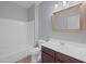 Bathroom featuring a tub/shower, vanity, modern fixtures, and an accent mirror at 3822 E Amber Ln, Gilbert, AZ 85296